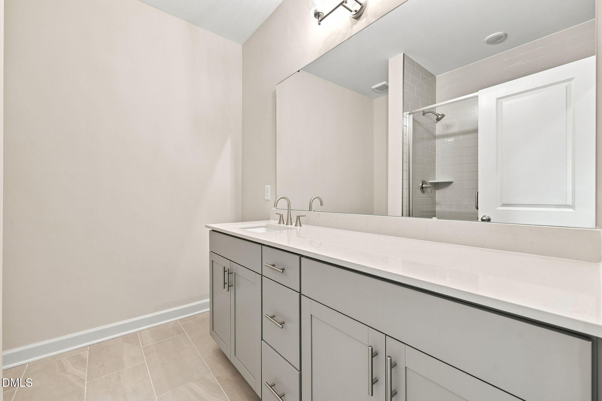 Modern bathroom vanity with quartz countertop and gray cabinets in The Magnolia B floor plan, Retreat at North Main.