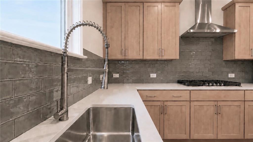 Modern kitchen with stainless steel farmhouse sink and gray subway tile backsplash in Hickory C floor plan, Wehunt Meadows.