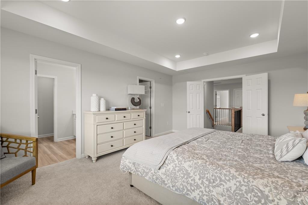 Spacious primary bedroom with tray ceiling in The Wake B floor plan at Hemingway by Davidson Homes in Cumming, Georgia.