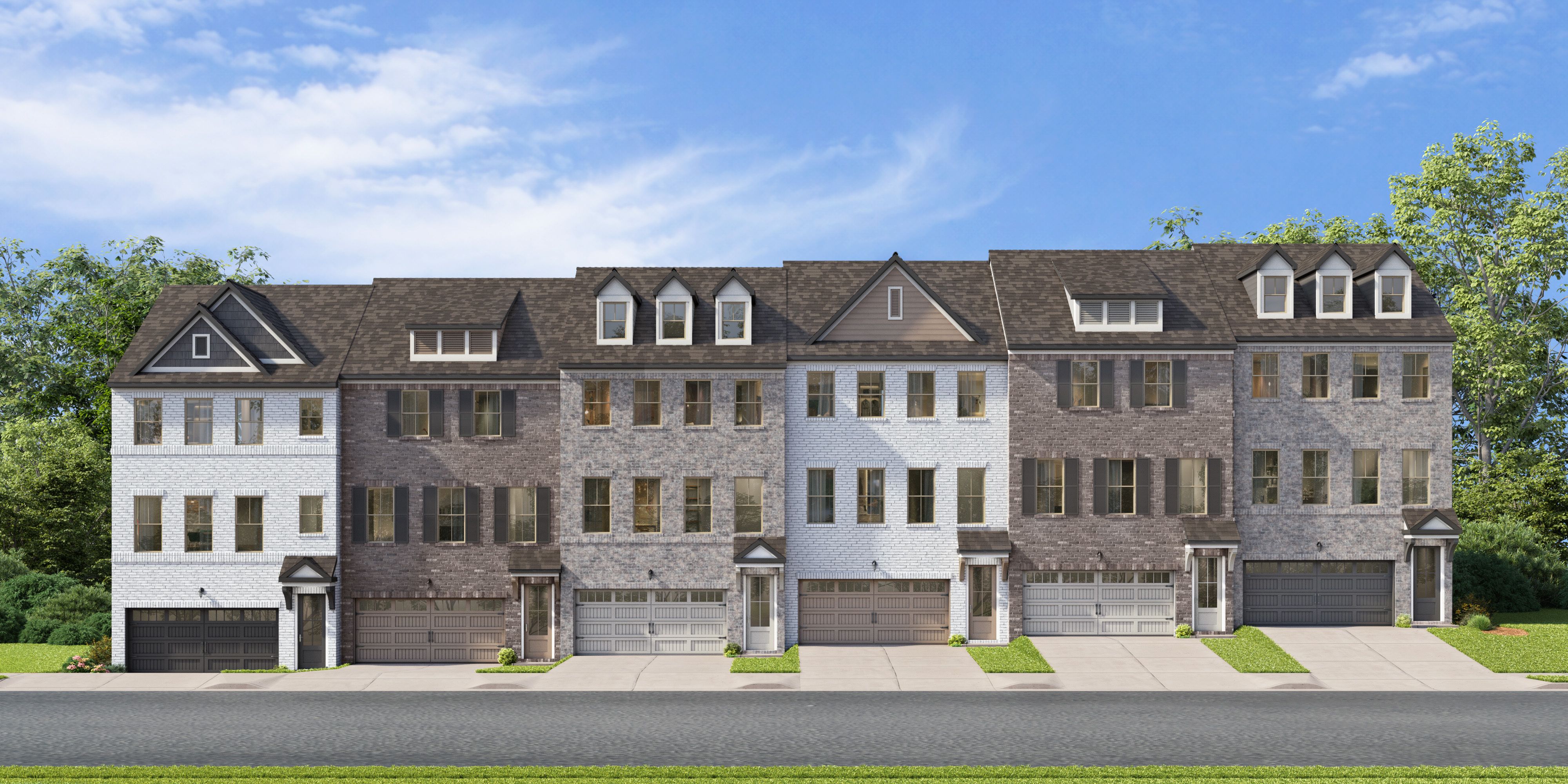 Three-story brick townhomes at Jackson Village in Hendersonville, TN, built by Davidson Homes with attached garages.