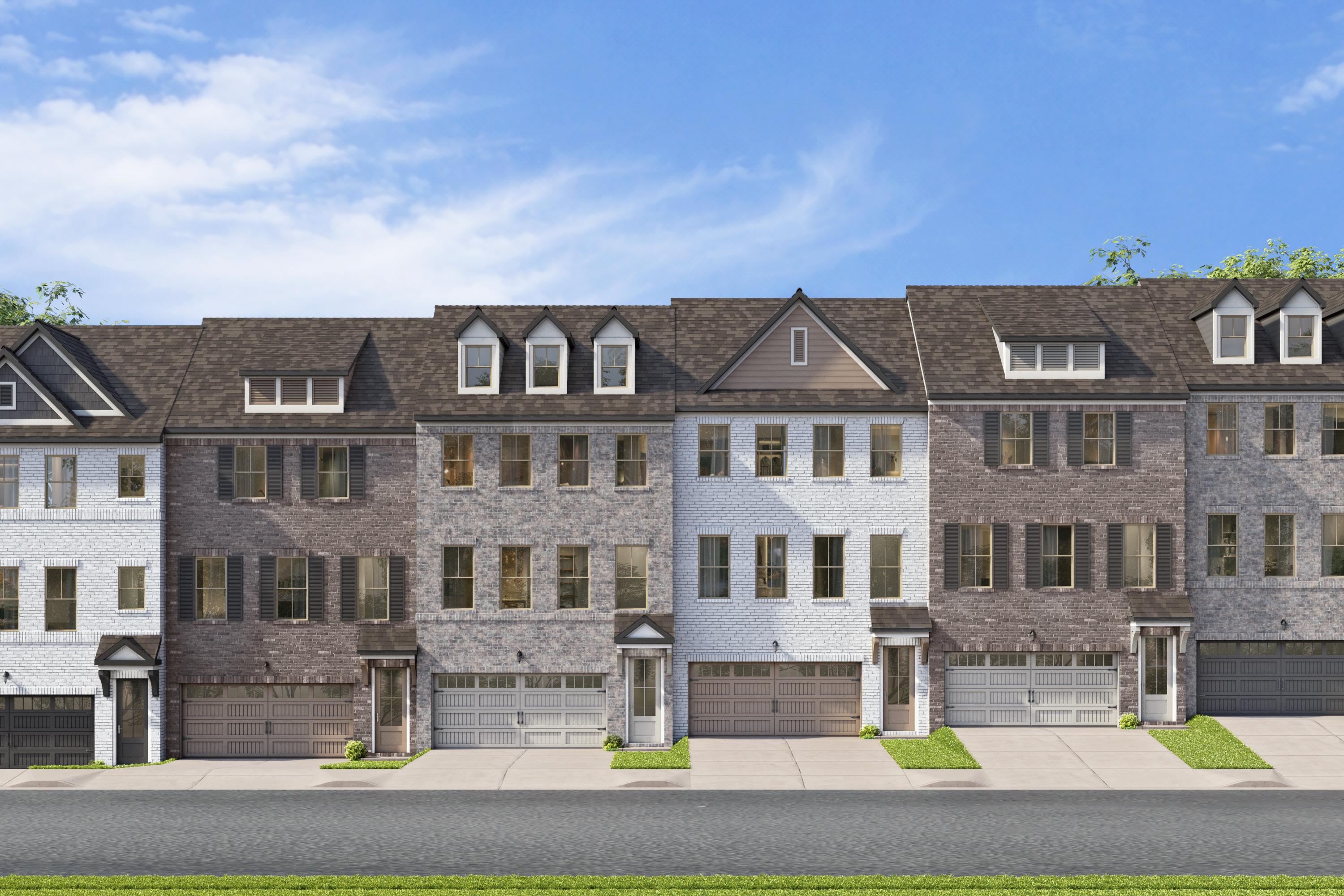 Three-story brick townhomes at Jackson Village in Hendersonville, TN, built by Davidson Homes with attached garages.