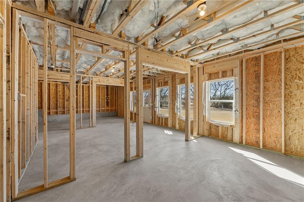 Exposed wooden framing and insulation in open interior of The Willow B- Unfinished Basement home by Davidson Homes, Hoschton, Georgia