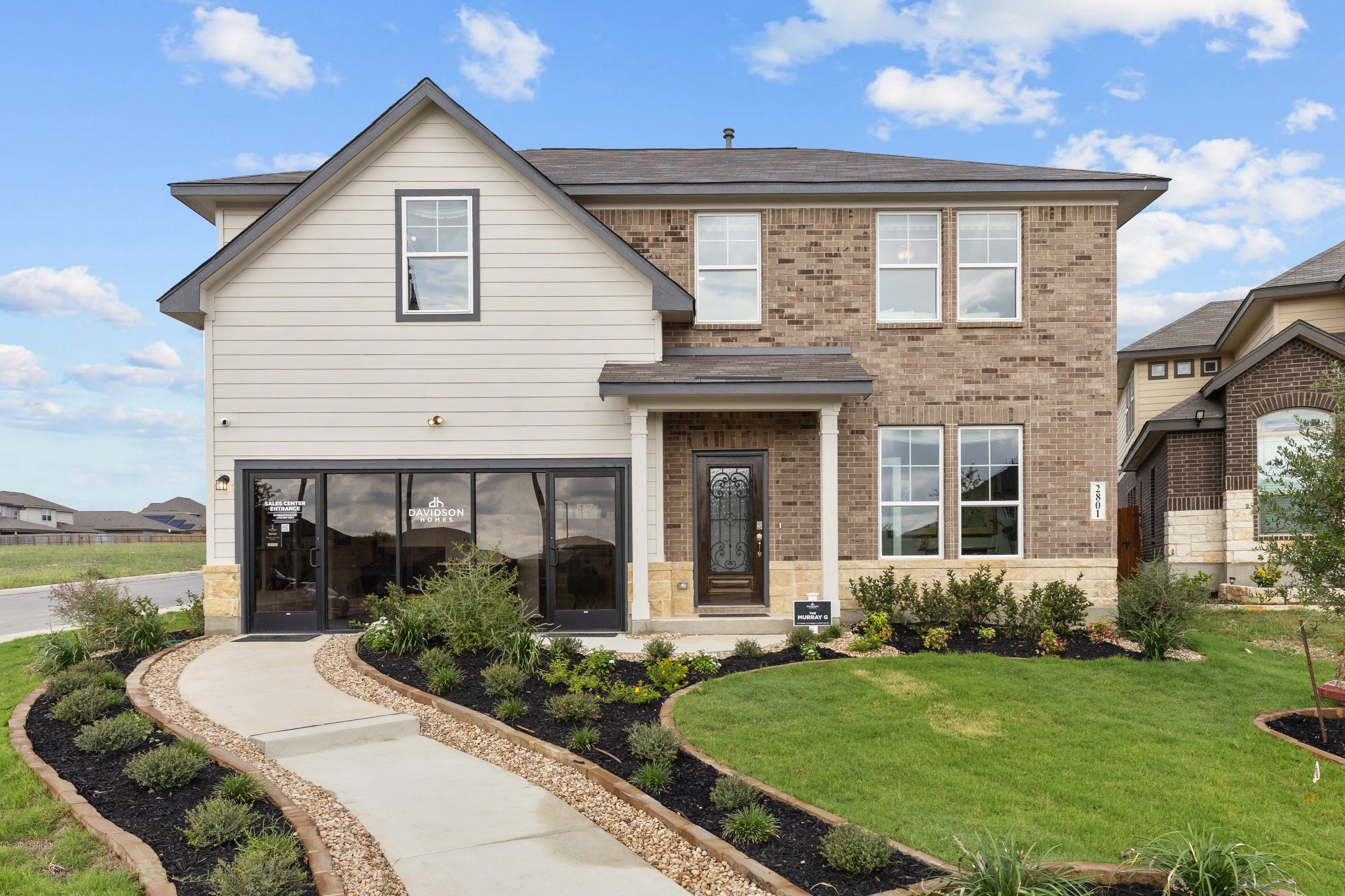 Contemporary brick and siding home exterior at Horizon Pointe in Converse, Texas with covered porch and curved walkway