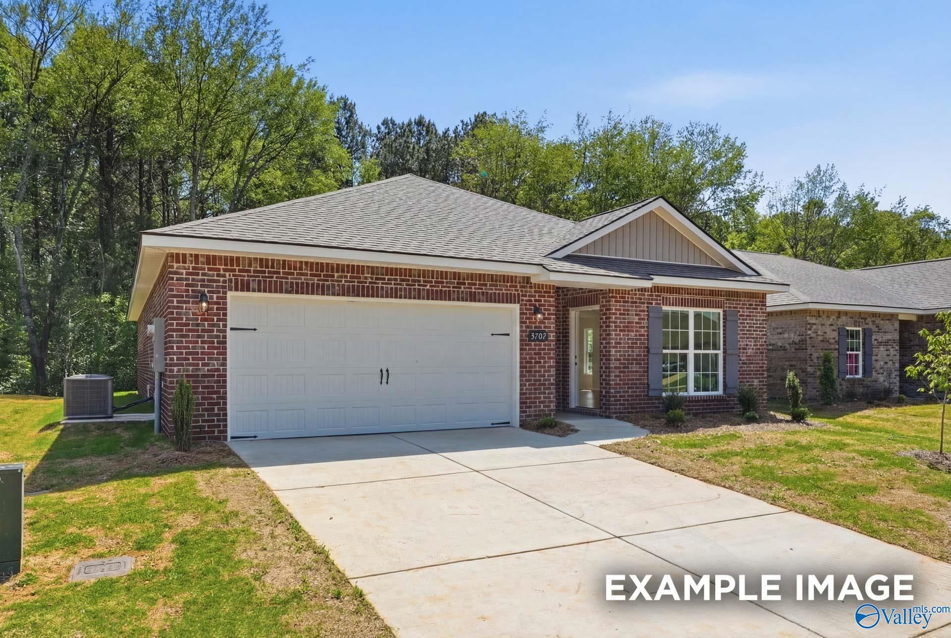 Single-story red brick home with 2-car garage, The Franklin C floor plan by Davidson Homes in The Highlands, Arab, Alabama.