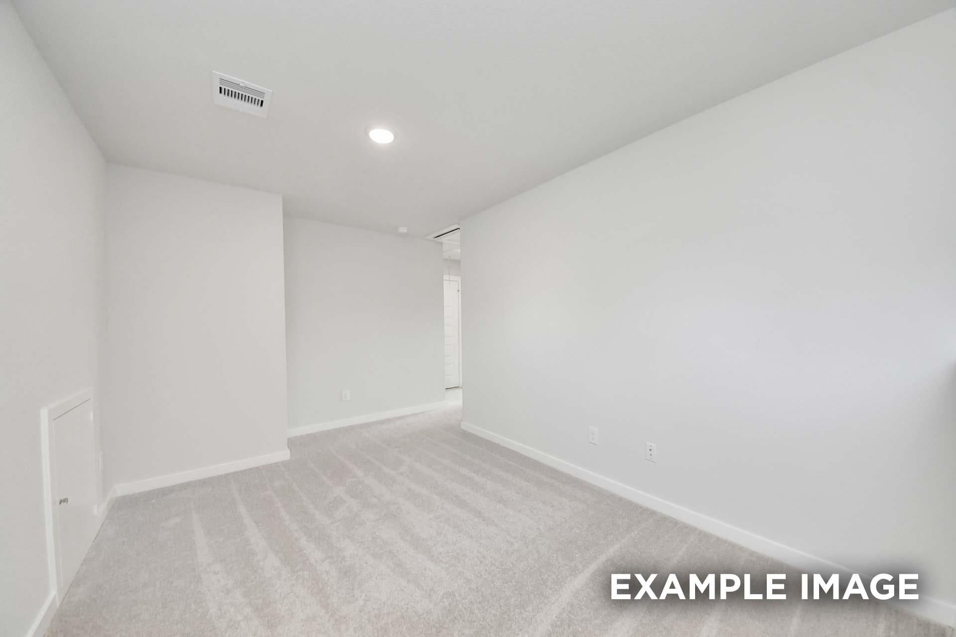Bright empty bedroom with plush carpet and neutral walls in Davidson Homes' The Blanco E at Windmill Estates, Magnolia, Texas