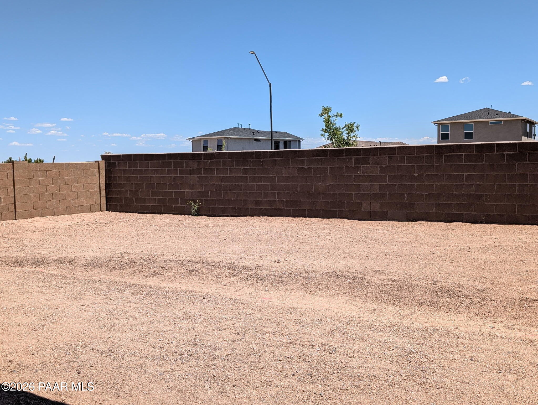 Private fenced backyard with desert landscaping in the South Ranch Western Collection, Prescott, Arizona.
