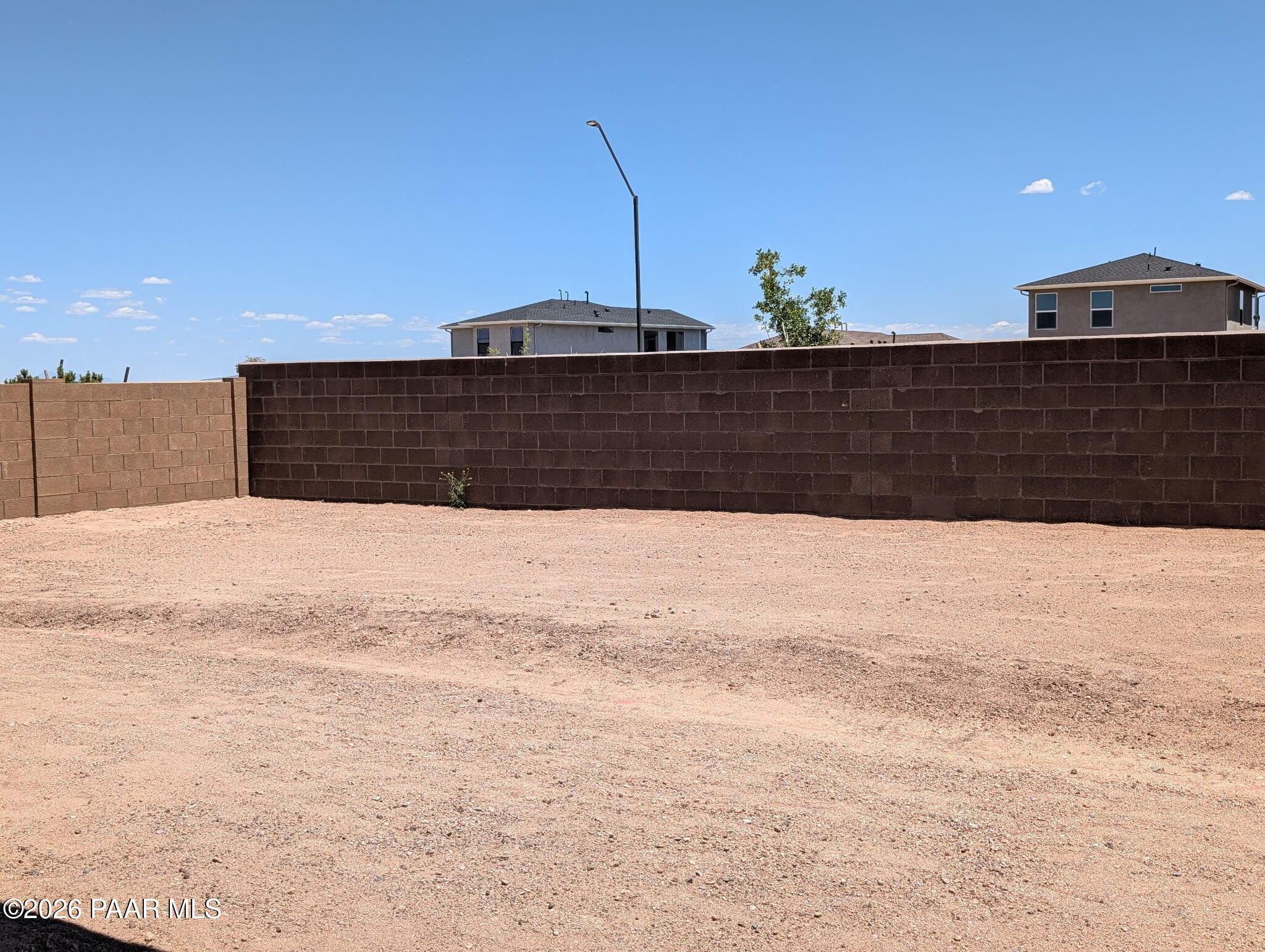 Private fenced backyard with desert landscaping in the South Ranch Western Collection, Prescott, Arizona.