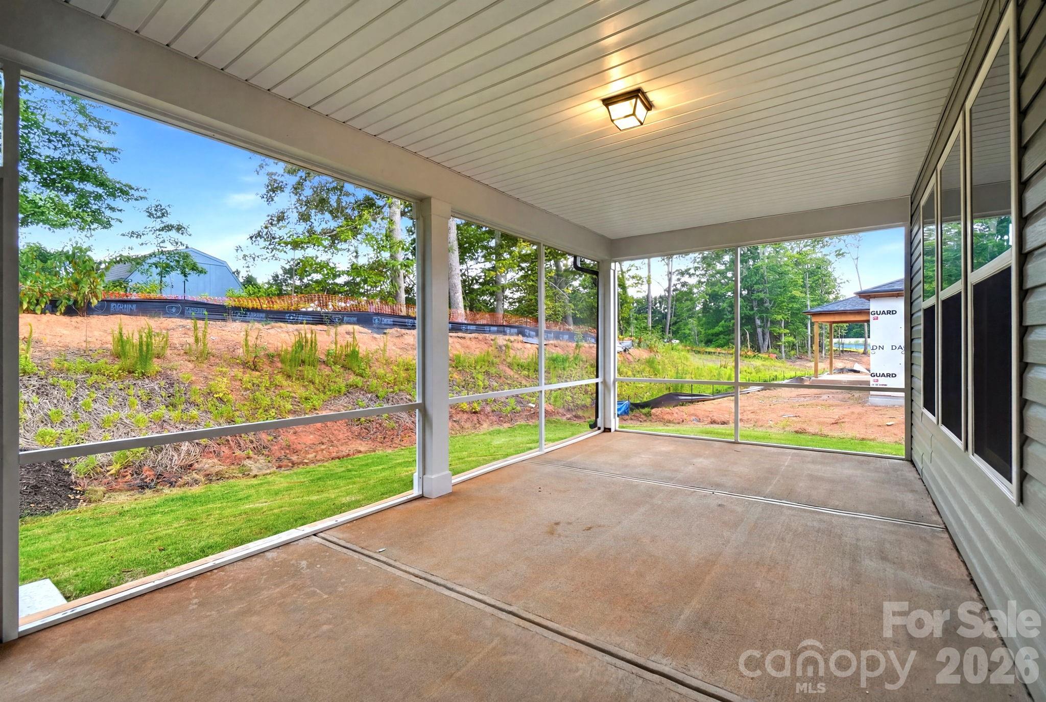 Screened-in back porch overlooking a yard in The Magnolia B floor plan by Davidson Homes in Windgate, Mooresville, NC.