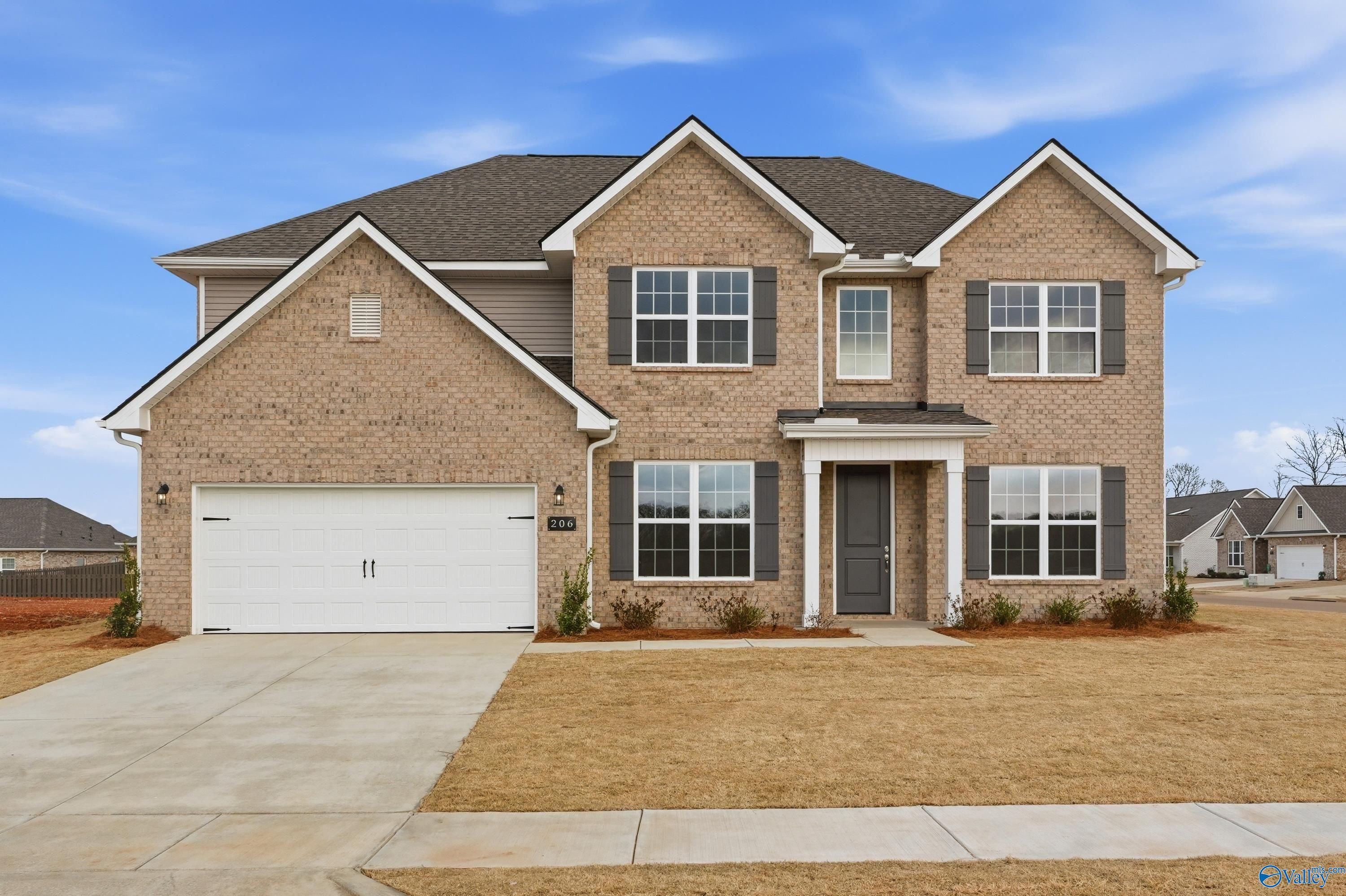 Two-story brick home with gabled roof, covered porch, 2-car garage in Pikes Ridge, Meridianville, Alabama - Davidson Homes The Madison A