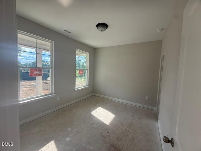 Bright, unfinished bedroom with large windows in The Chestnut floor plan by Davidson Homes in Montrose, Aberdeen, NC.