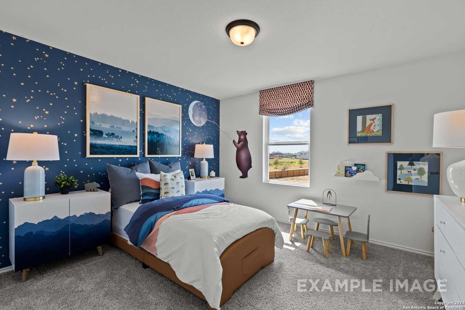 Cozy kids' bedroom with starry blue walls, mountain art, teddy bear, bed, desk in Davidson Homes The Douglas G, Bricewood, San Antonio