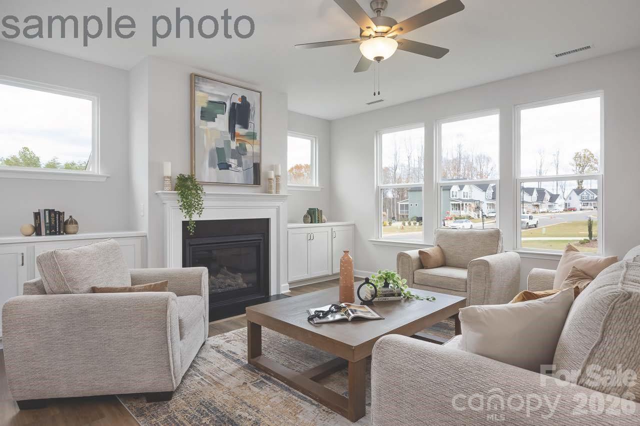 Bright living room with fireplace and built-in cabinets in The Chestnut D floor plan at Enclave at Belmont, North Carolina.