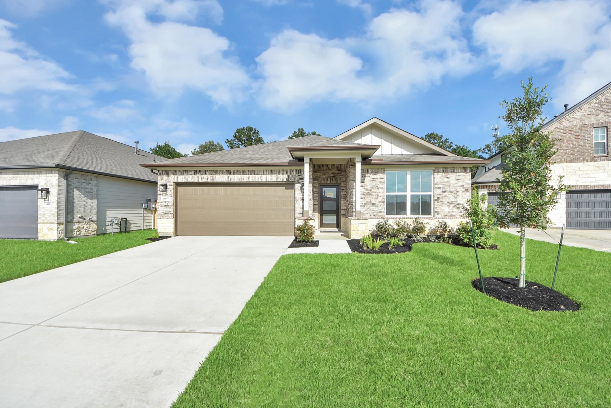 Brick exterior of The Daphne F floor plan by Davidson Homes featuring 2-car garage in Sundance Cove, Crosby, Texas.