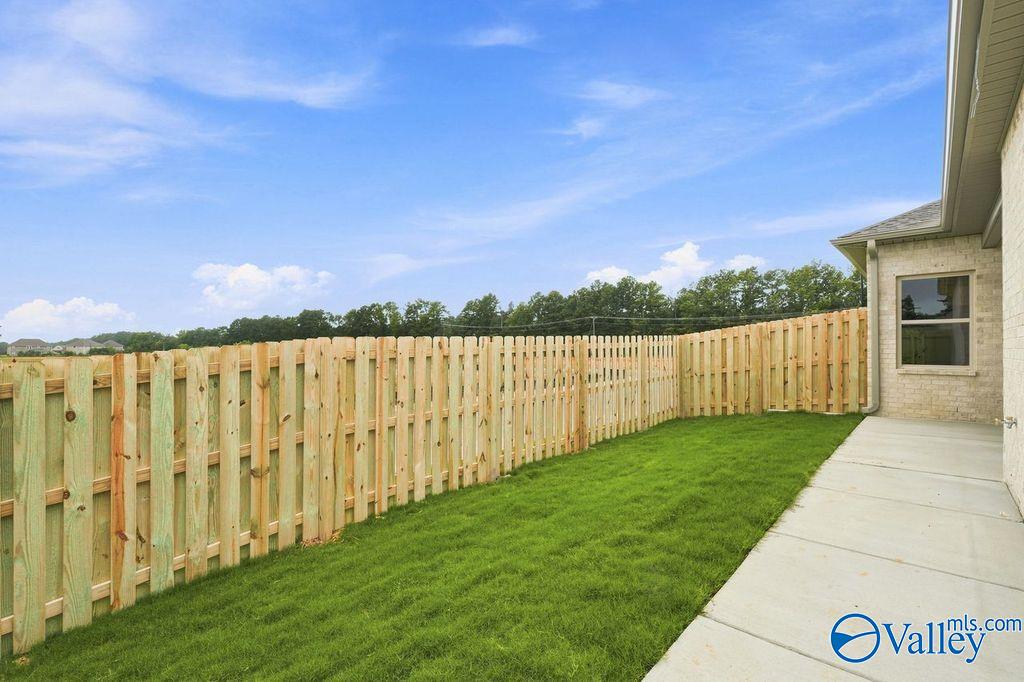 Private fenced backyard with concrete patio at The Camilla B floor plan home in The Retreat at Cain Park, Hartselle, AL.