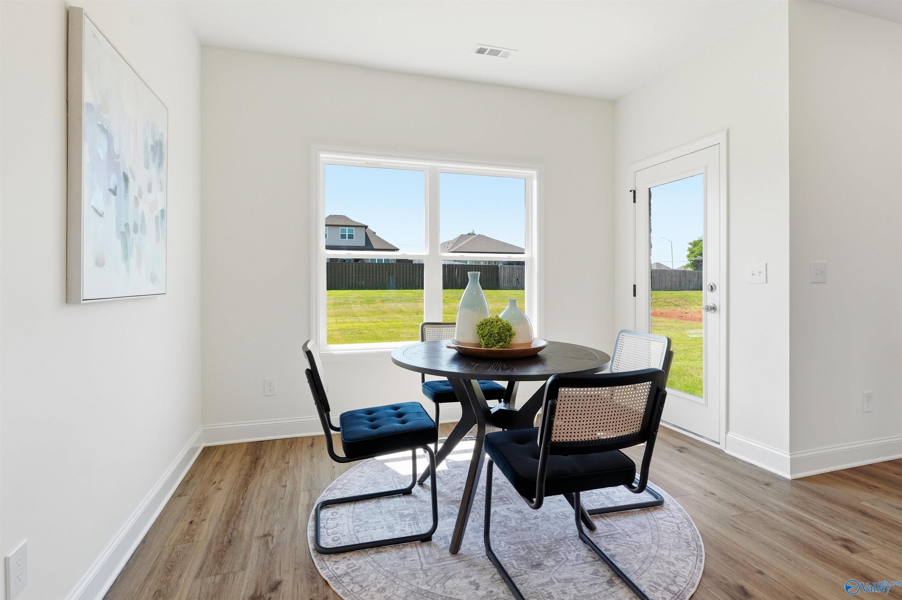 Bright breakfast nook with modern dining set in The Franklin C floor plan at Lynn Meadows, Meridianville, Alabama.