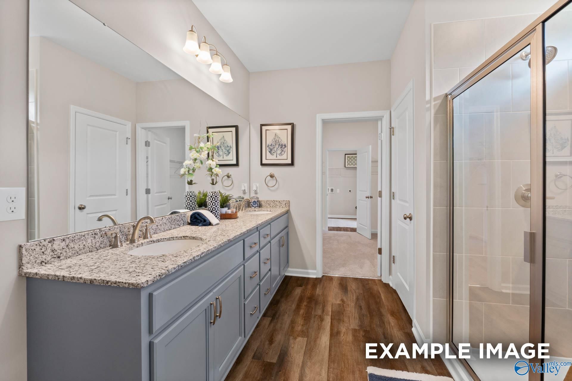 Modern master bathroom with double vanity, quartz countertop, gray cabinets, walk-in shower in Evermore Homes The Arcadia M, Owens Cross Roads, AL