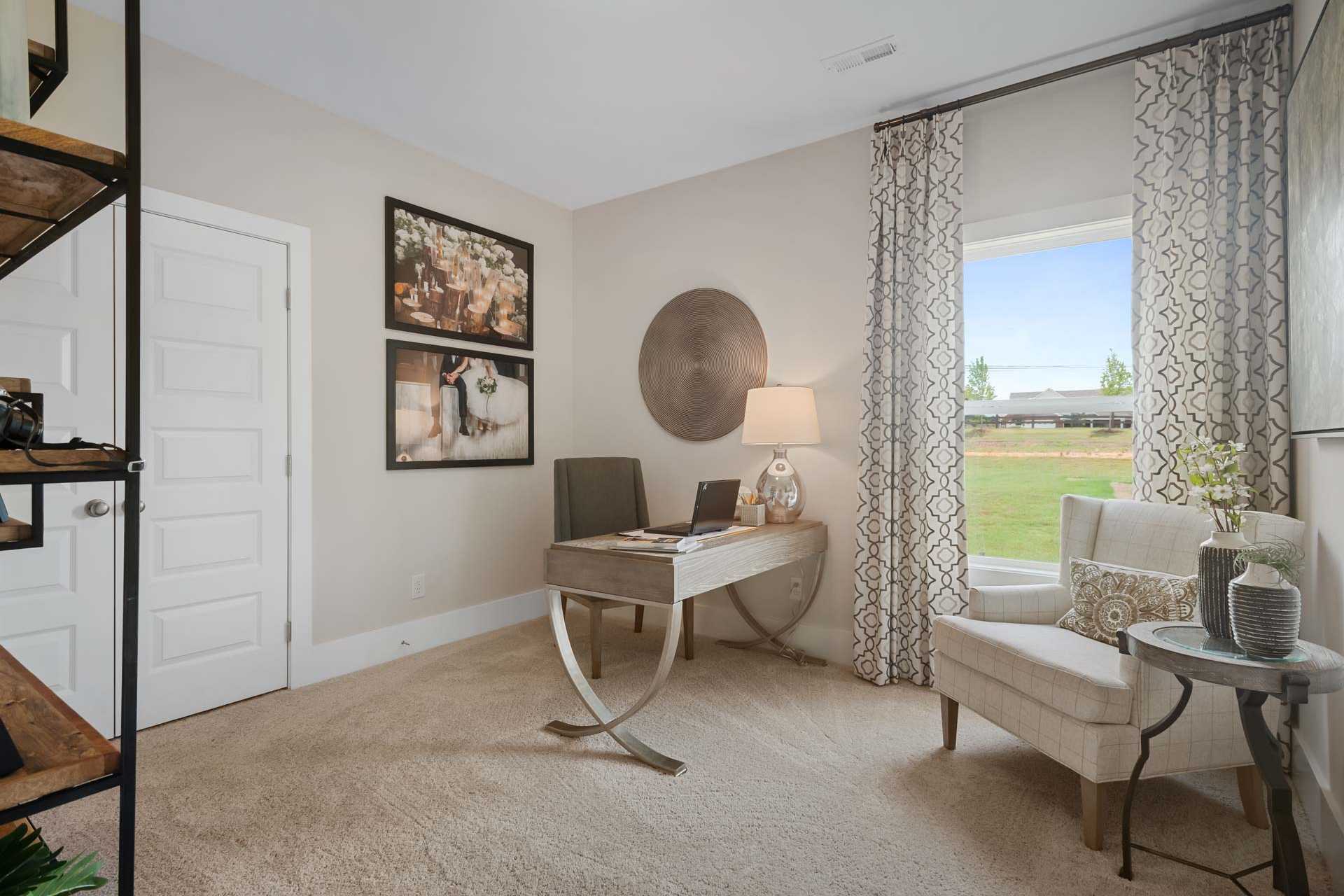 Cozy home office at Flint Meadows in New Market Alabama with sleek desk laptop window view and neutral decor