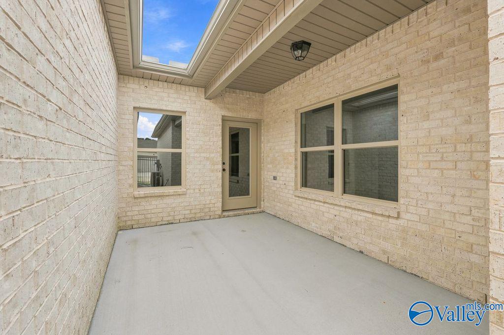 Private covered patio with brick walls at The Camilla C floor plan in The Retreat at Cain Park, Hartselle, Alabama.