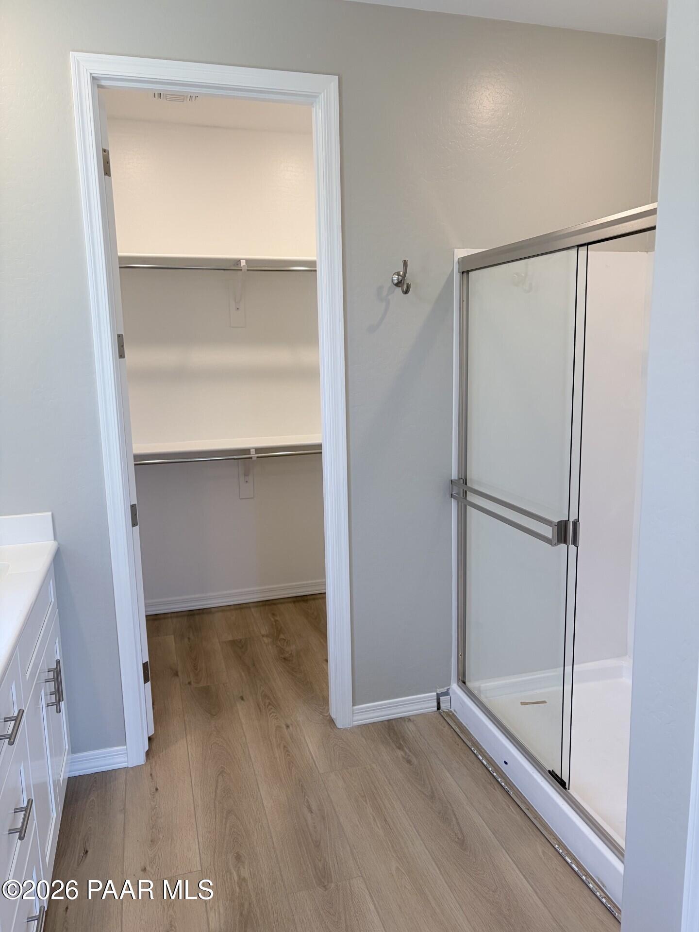 Bathroom with walk-in closet and glass-enclosed shower in The Frontier A floor plan at North Ridge, Prescott Valley.