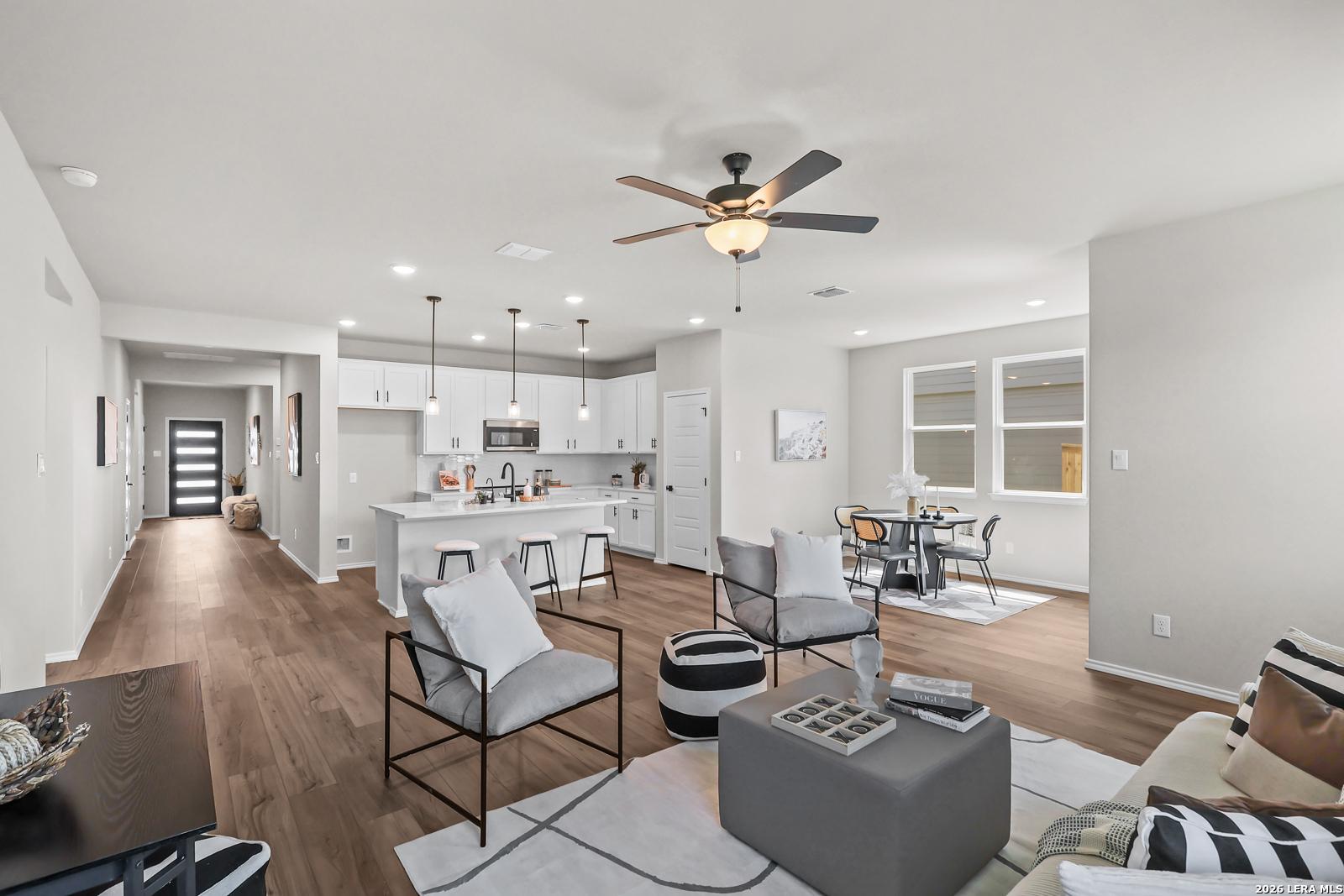 Open-concept living room and kitchen in The Daphne H floor plan by Davidson Homes in Hannah Heights, Seguin, Texas.