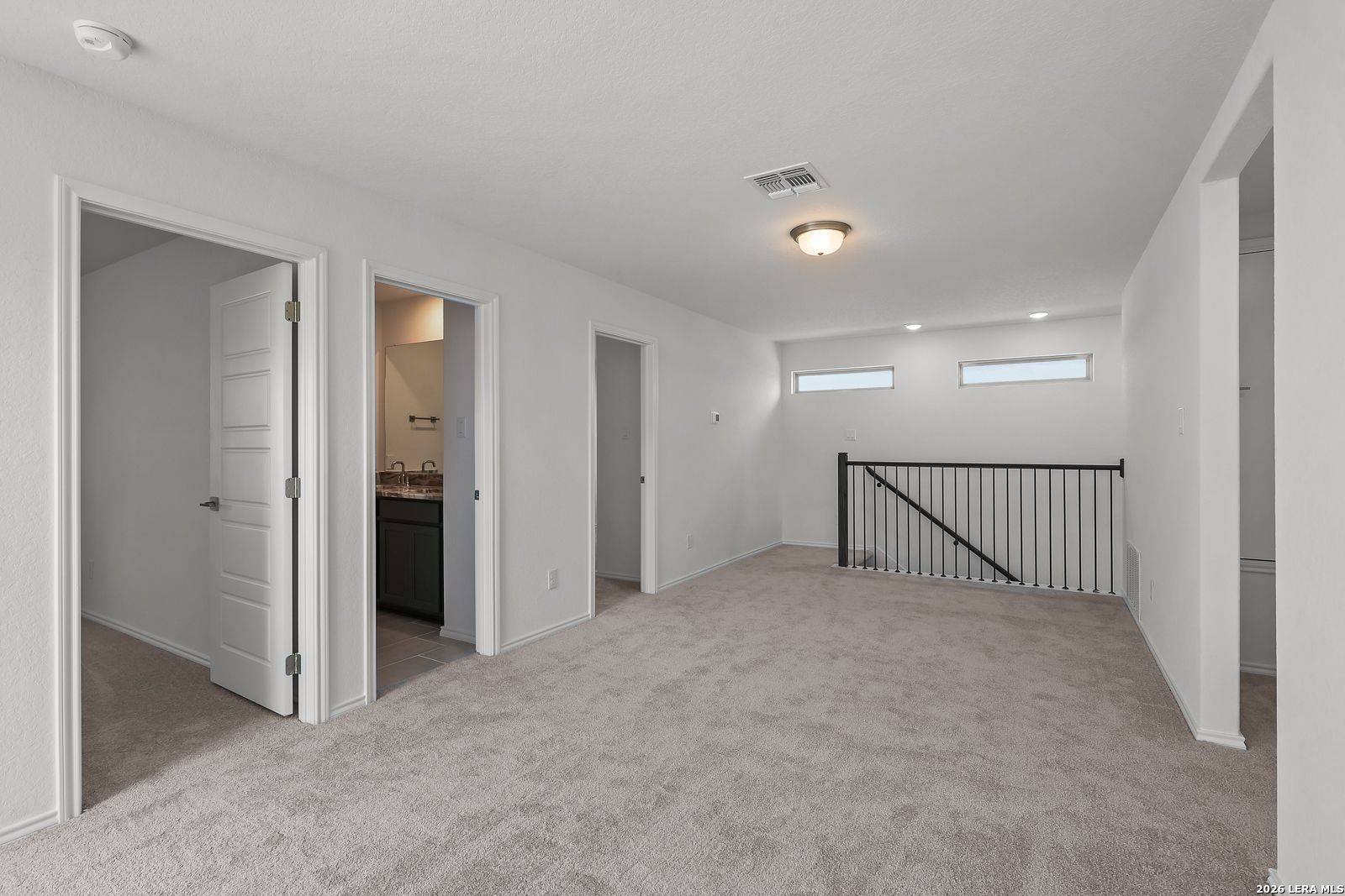 Spacious carpeted upstairs loft in The Brazos B floor plan by Davidson Homes in Agave, San Antonio, Texas.
