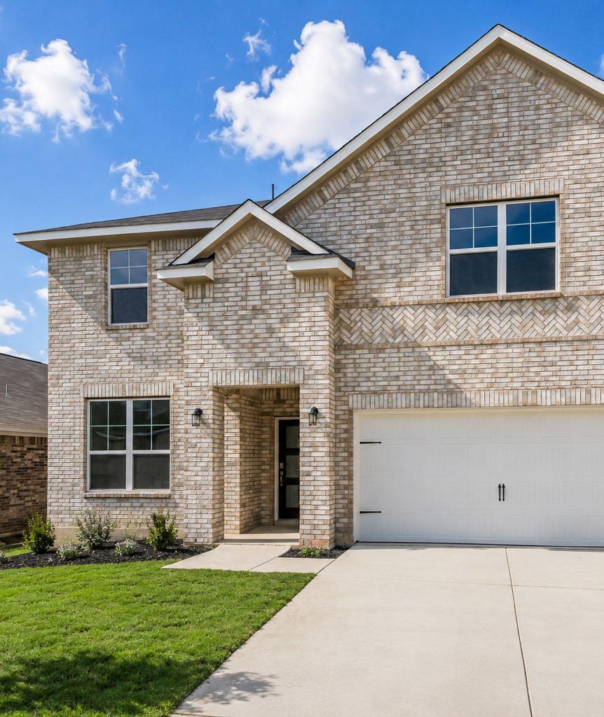 Two-story brick exterior of a Davidson Homes house at Morgan Meadows in San Antonio, Texas with a two-car garage.