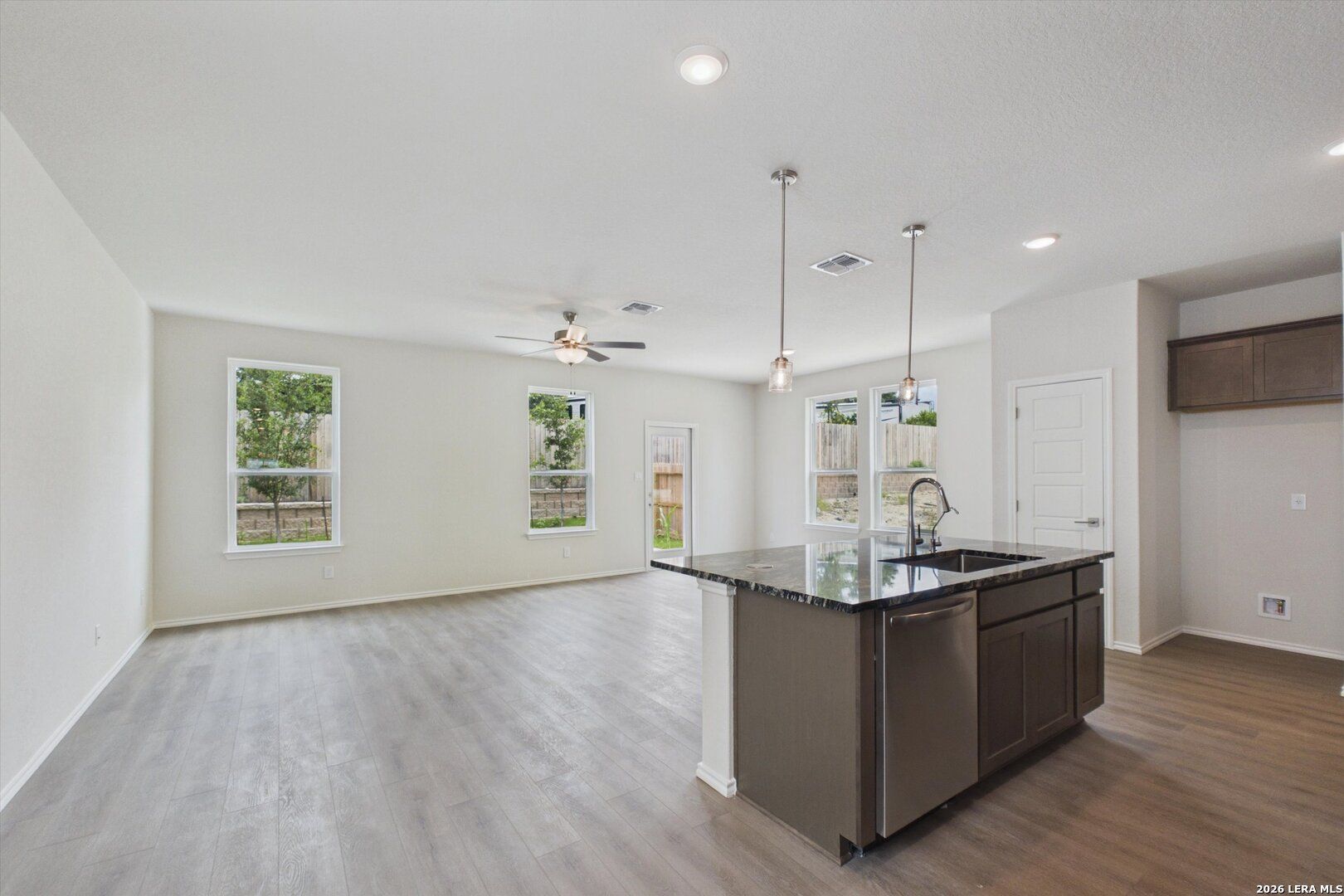 Open-concept kitchen and living area in The Charlotte B floor plan at Meadows at Oak Creek, San Antonio, Texas.