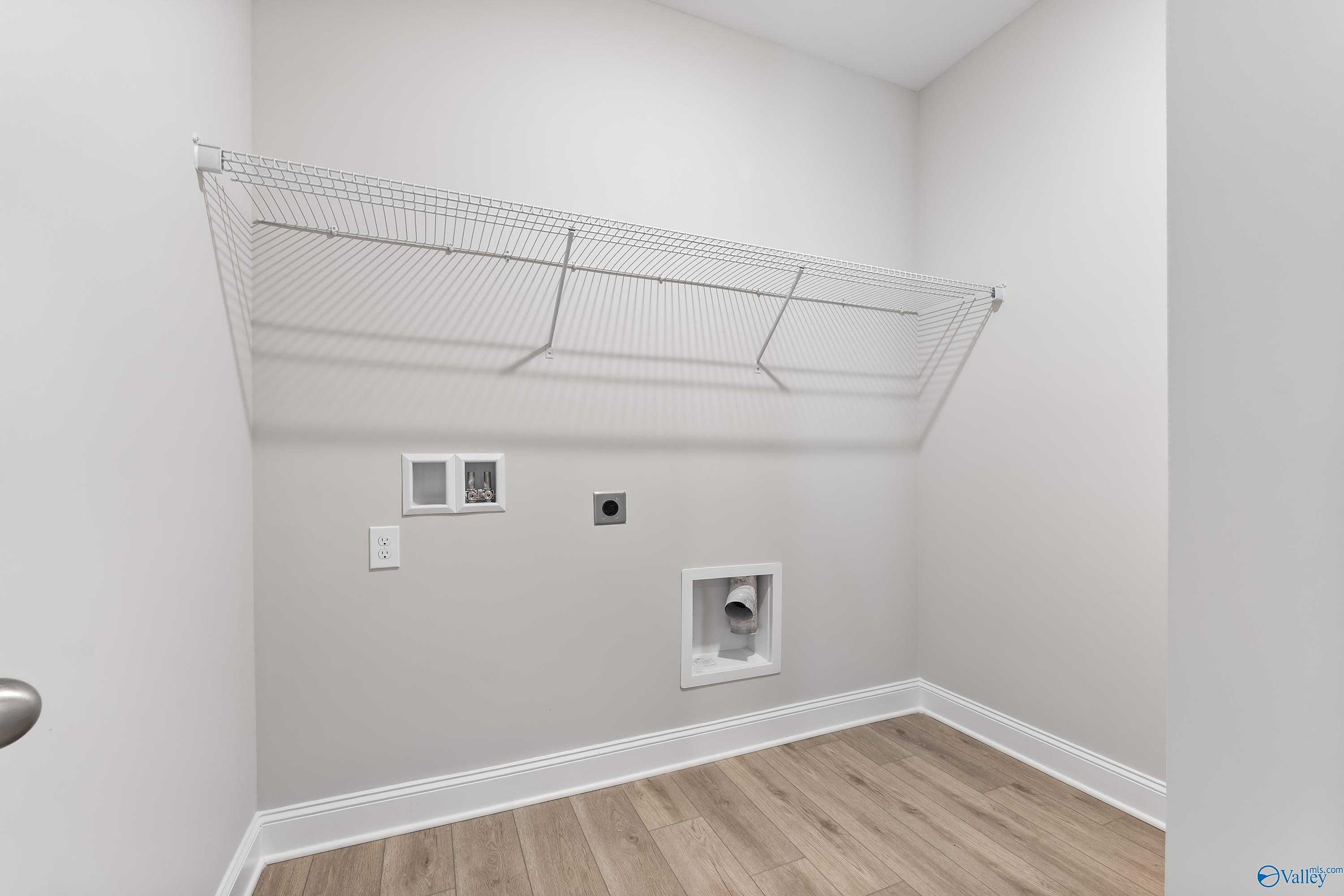 Spacious laundry room with wire shelving, washer dryer hookups in Davidson Homes The Daphne C, Huntsville, Alabama