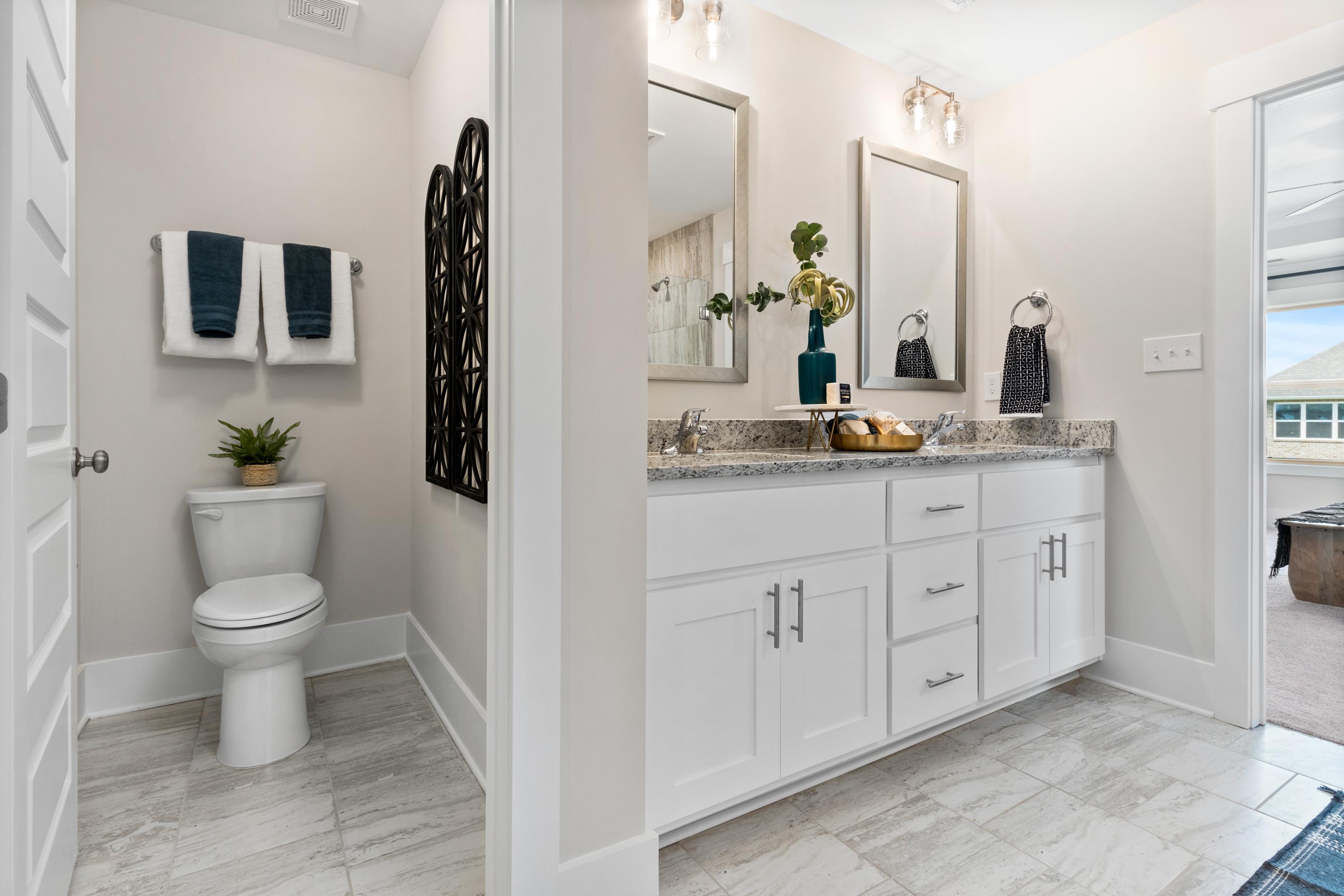 Spacious master bathroom in The Chelsea A featuring double vanity, white cabinets, and tiled flooring
