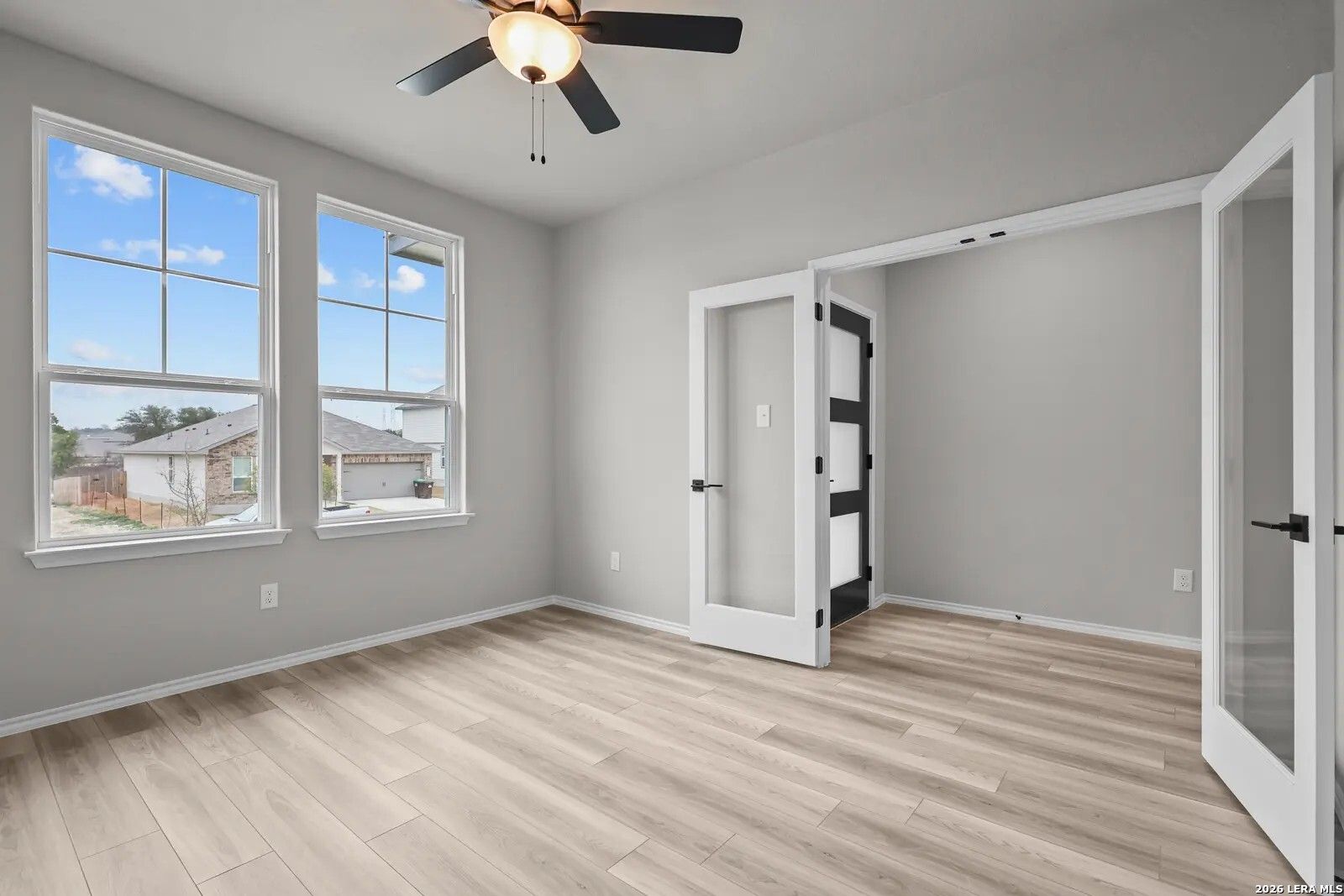 Bright home office with French doors and light wood flooring in The Glenwood E floor plan at Comanche Ridge, San Antonio.