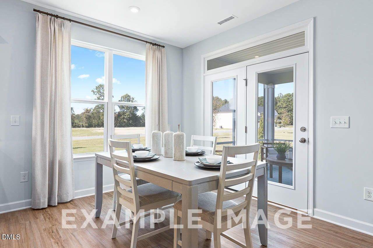Bright dining area with French doors to covered patio in Davidson Homes The Ash C, Retreat at North Main, Lillington, NC