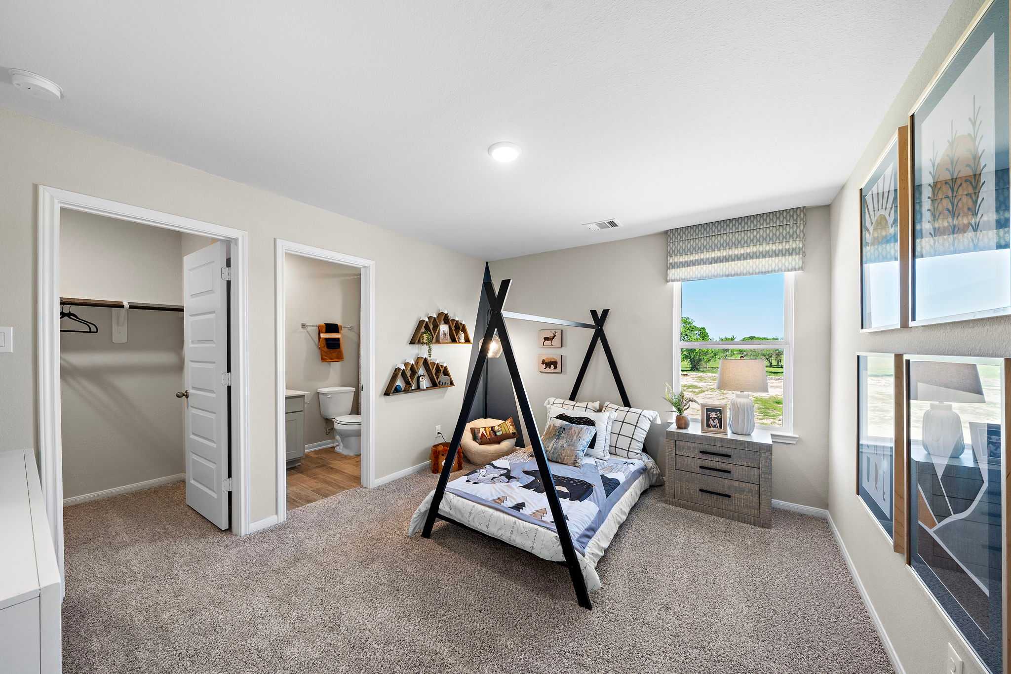 Modern boy's bedroom at Emberly in Beasley Texas with teepee bed frame, decorative art, and window view