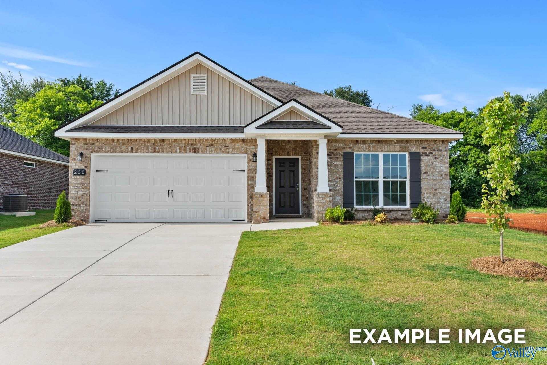 Modern single-story home with beige brick exterior, 2-car garage, and covered entry in The Highlands, Arab, Alabama