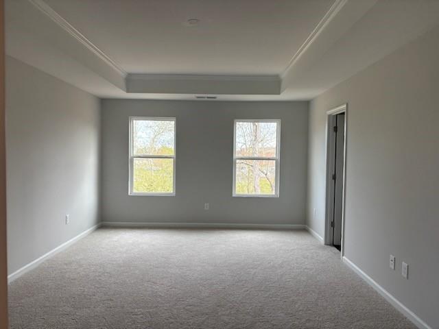 Bright empty bedroom with tray ceiling, large windows, light gray walls, and carpet in Davidson Homes The Marion A, Winder, GA