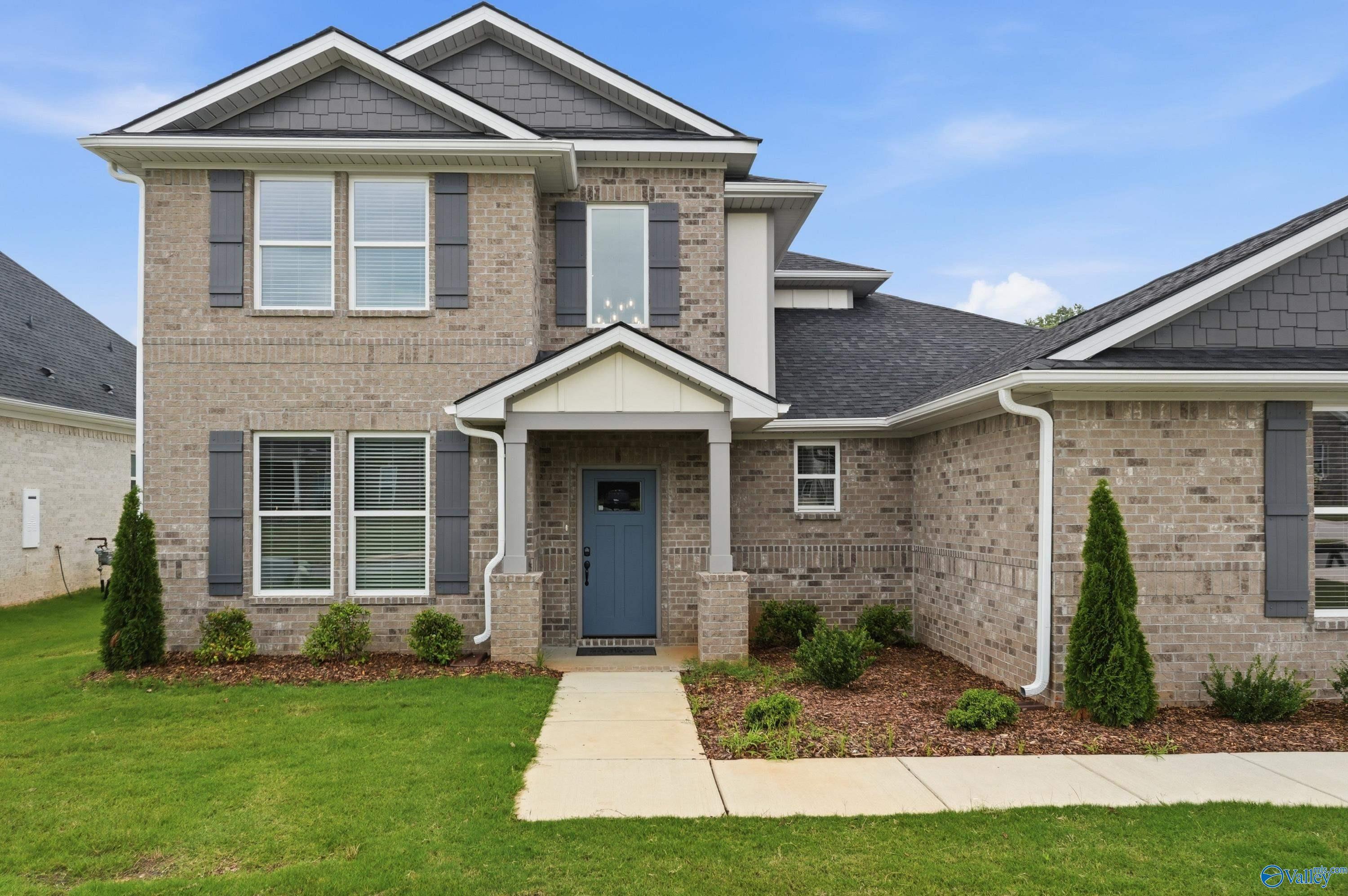 Two-story brick exterior of The Dorado floor plan by Davidson Homes in Riverton Preserve, Huntsville, Alabama.