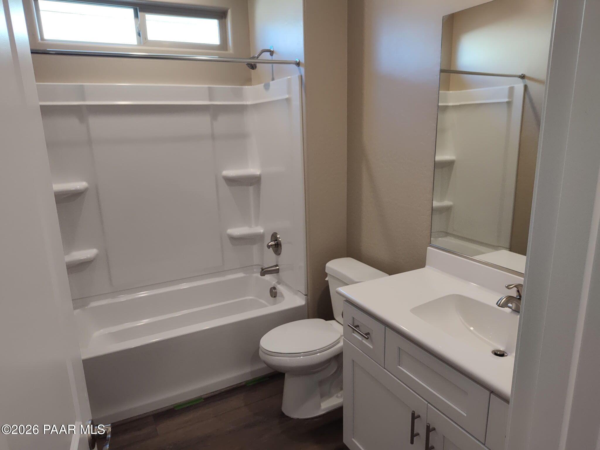 Full bathroom with white vanity and tub-shower combo in The Inspiration C floor plan at North Ridge, Prescott Valley.