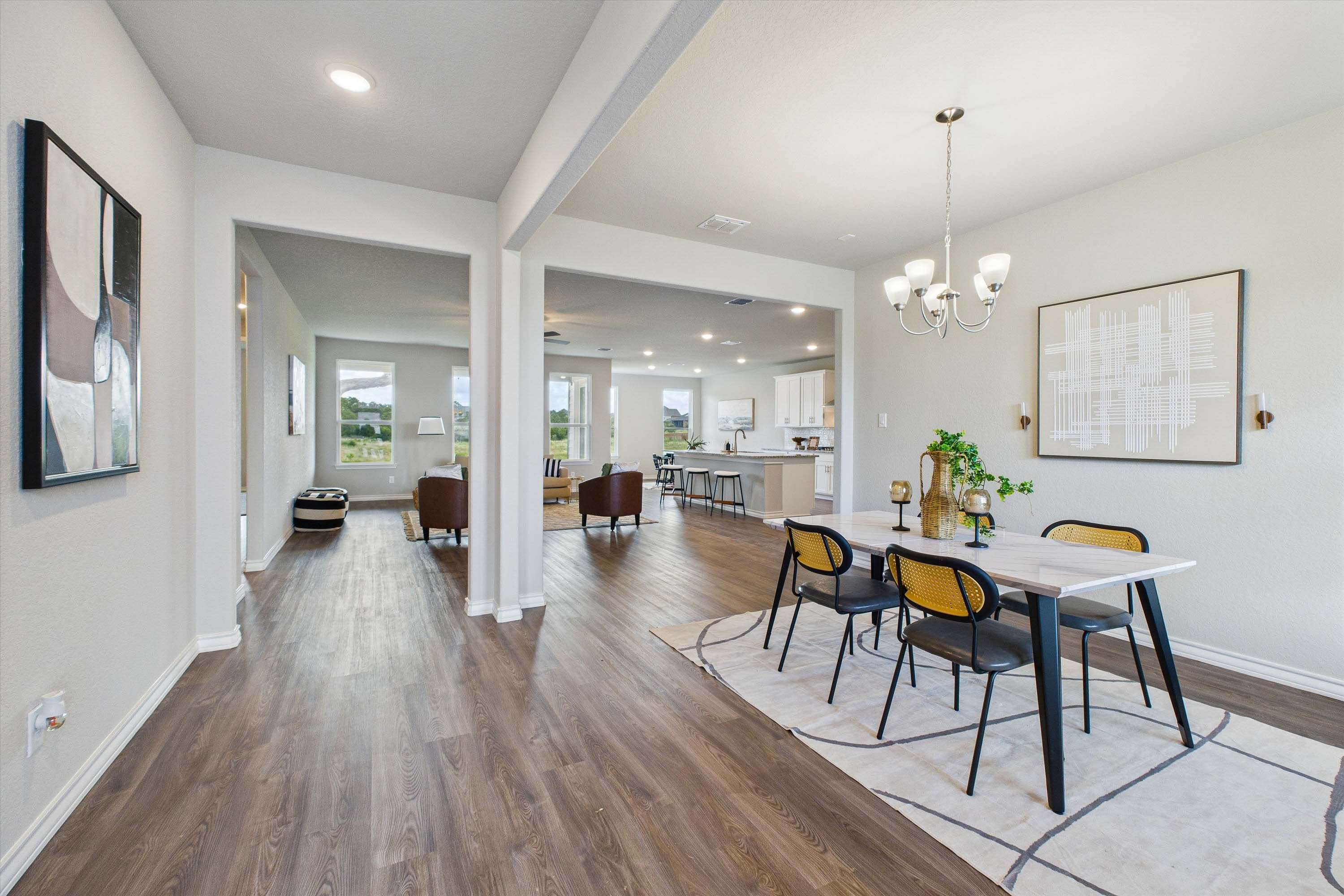 Open-concept dining and living area in The Foster E by Davidson Homes featuring modern finishes and wood-style flooring.