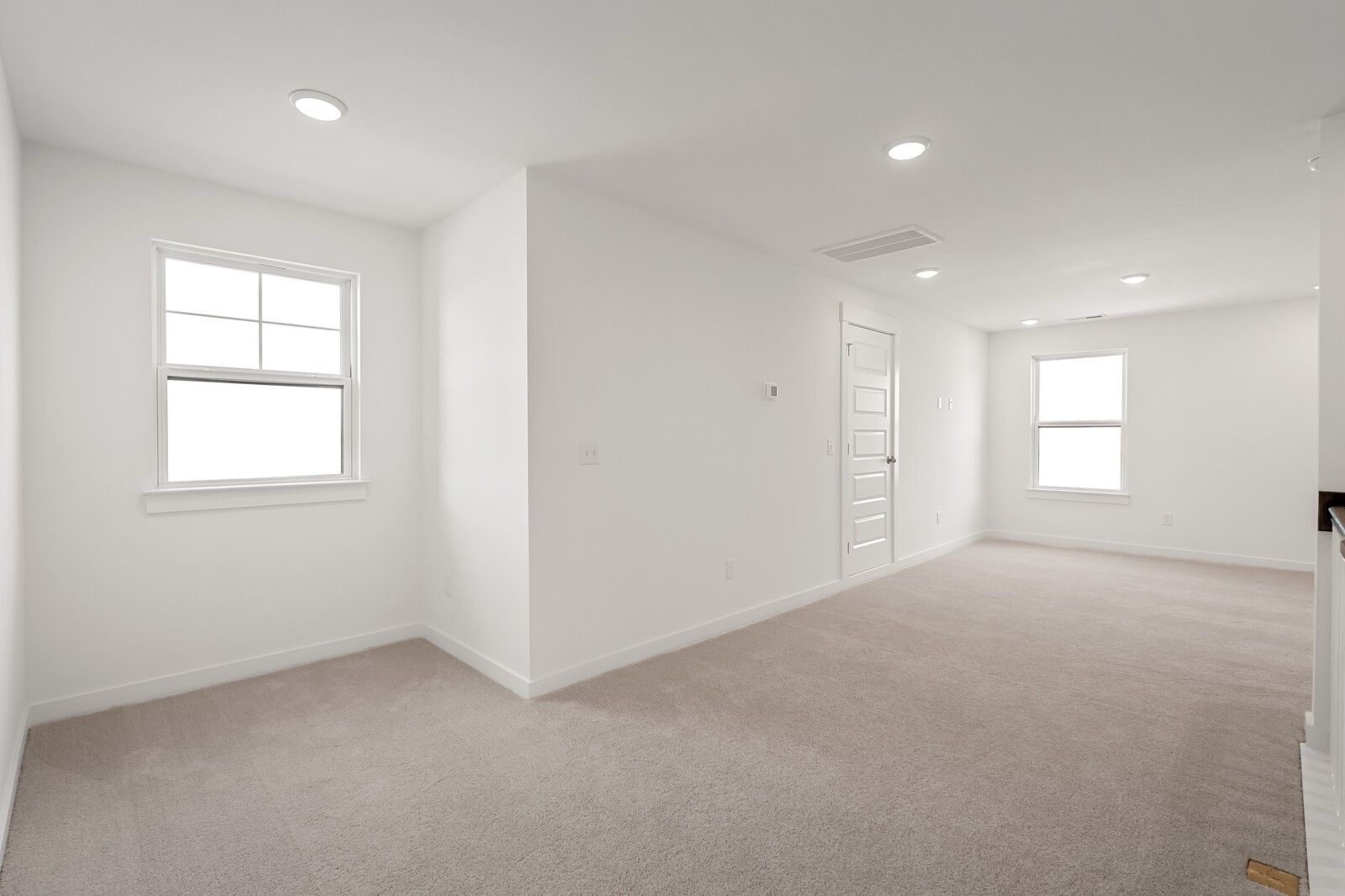 Bright upstairs bonus room with carpeted floors, white walls, large windows, and recessed lights in Davidson Homes The Ash C, Mt. Juliet, TN