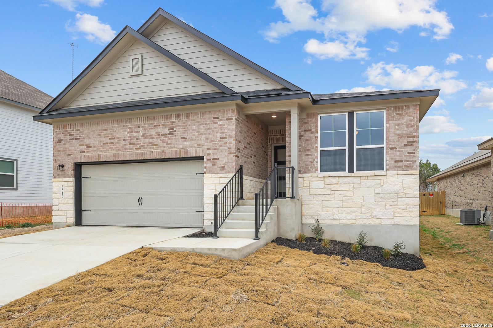 Brick and stone single-story home with 2-car garage, covered porch, and driveway in Royal Crest, San Antonio, TX – Davidson Homes The Glenwood F