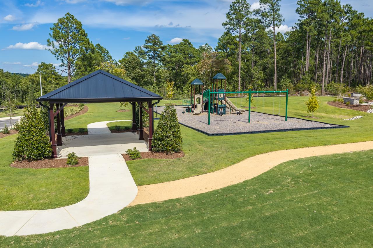 Community pavilion and playground with swings at Montrose by Davidson Homes in Aberdeen, North Carolina