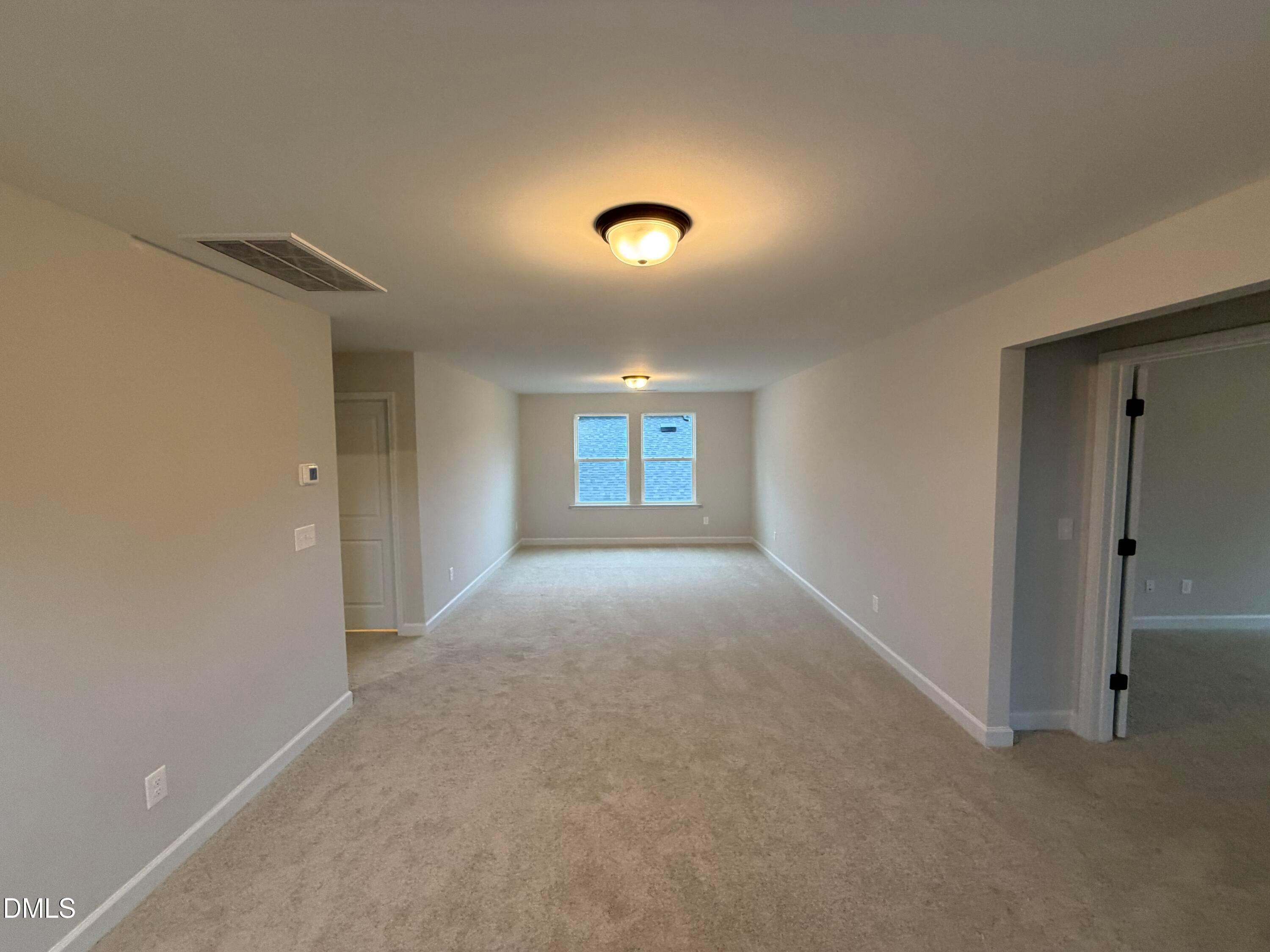 Spacious carpeted bedroom with dual windows and neutral walls in Davidson Homes' The Preston C, Wendell Ridge, North Carolina