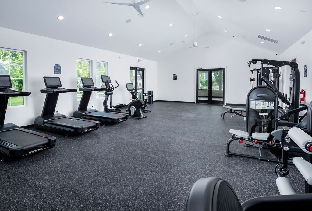 Modern gym with treadmills, ellipticals, weight machines, and rubber flooring in Shelton Square, Murfreesboro, Tennessee