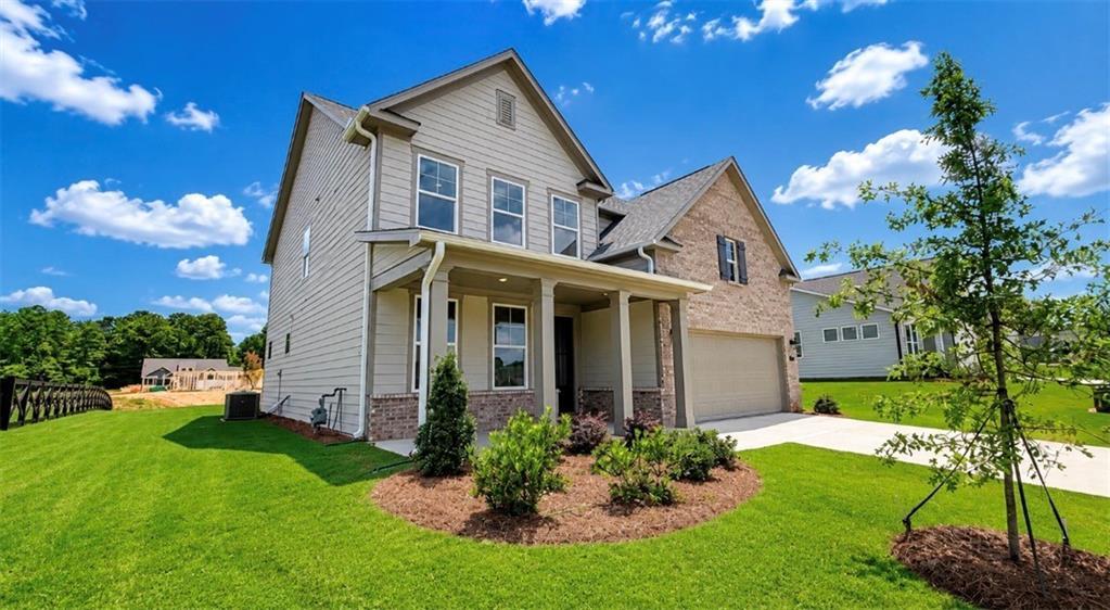 Two-story Hickory C floor plan by Davidson Homes with brick and siding exterior in Wehunt Meadows, Hoschton, Georgia.