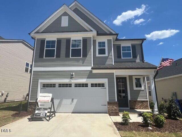 Modern two-story gray home with 2-car garage, front porch, and for sale sign in Gregory Village, Lillington, North Carolina - Davidson Homes Adalynn A