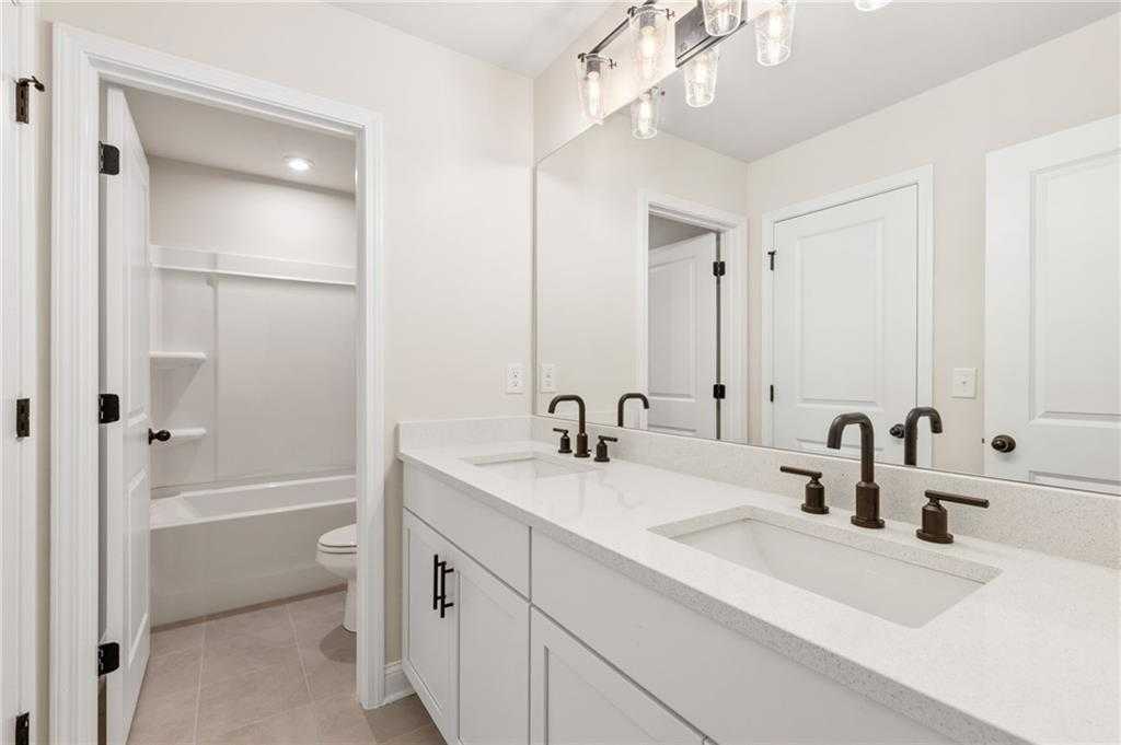 Modern bathroom with double vanity, freestanding tub, walk-in shower in Davidson Homes The Hickory B, Buford, GA