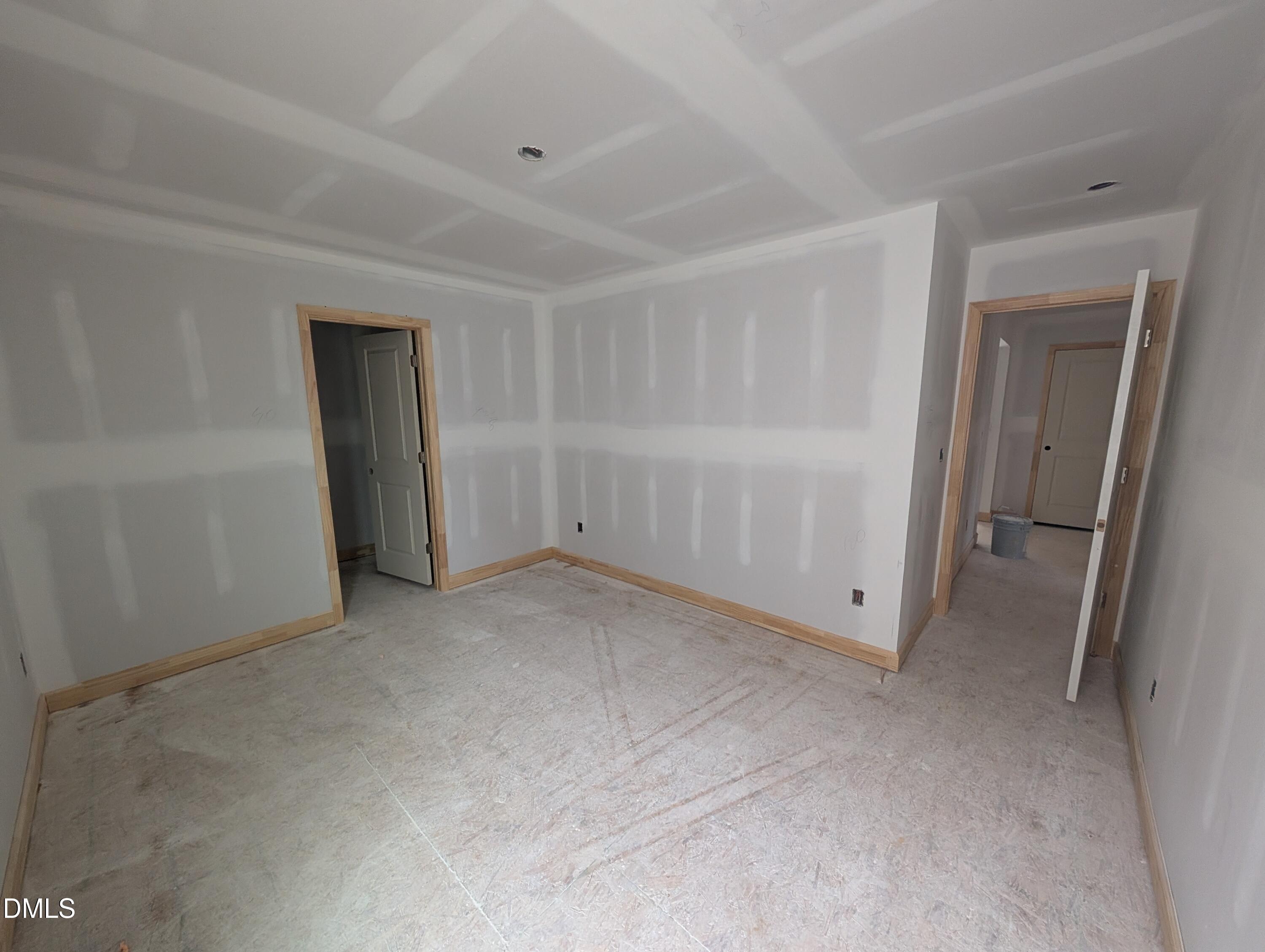 Unfinished bedroom with coffered ceiling detail and wood trim in Davidson Homes The Beech floor plan, Wendell Ridge, North Carolina