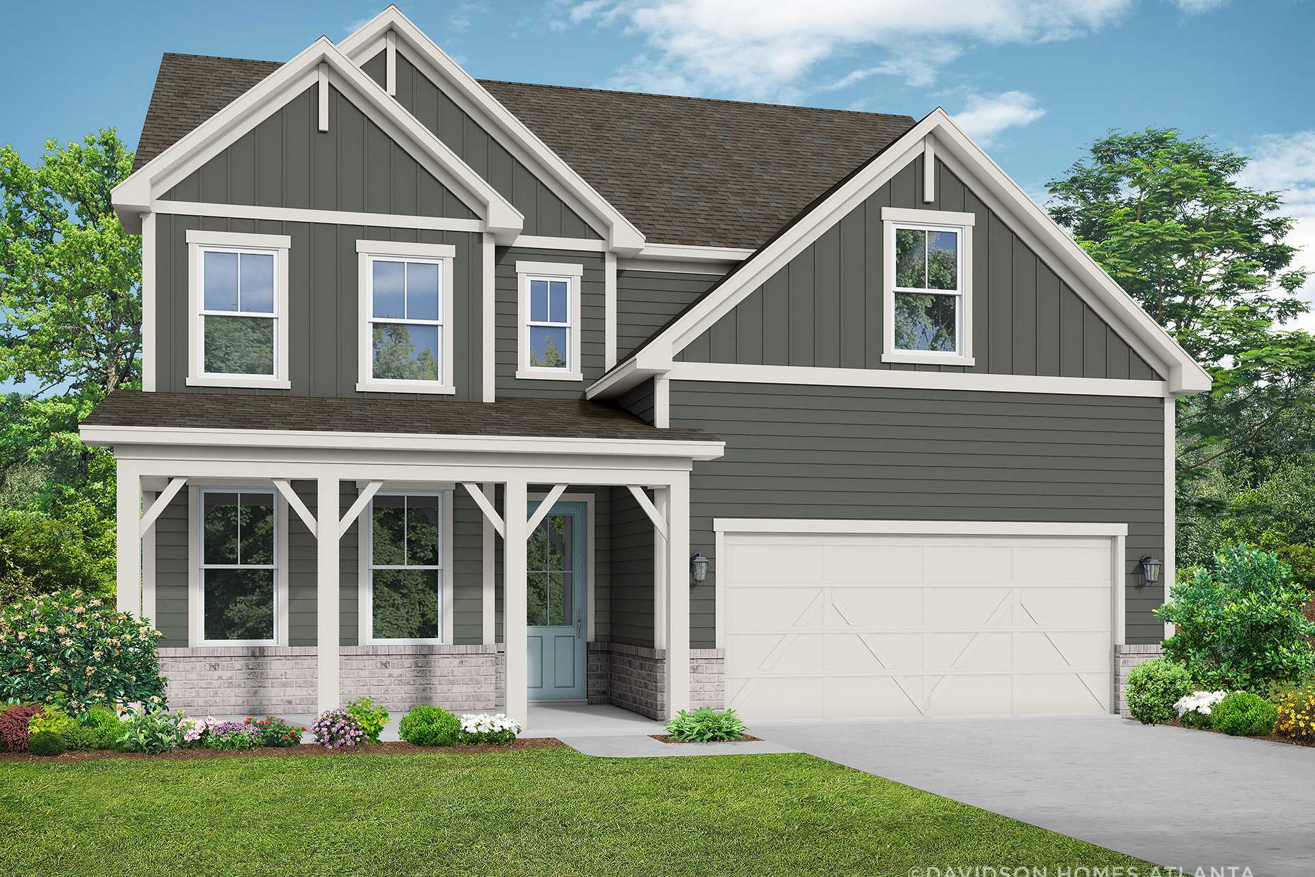 Two-story craftsman exterior of The Hickory B with gray siding, covered porch, two-car garage, and landscaped yard in Winder, GA