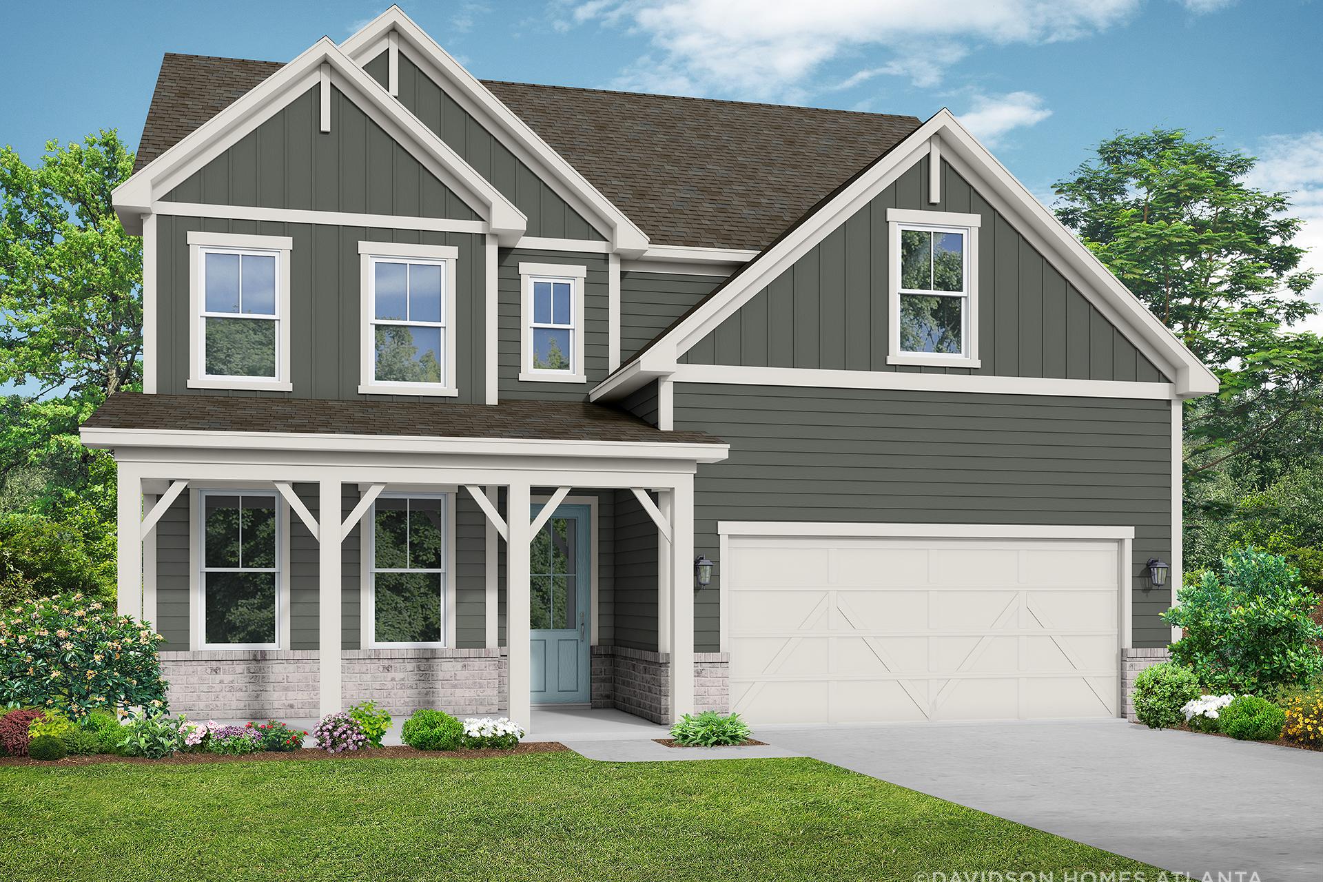 Two-story craftsman exterior of The Hickory B with gray siding, covered porch, two-car garage, and landscaped yard in Winder, GA