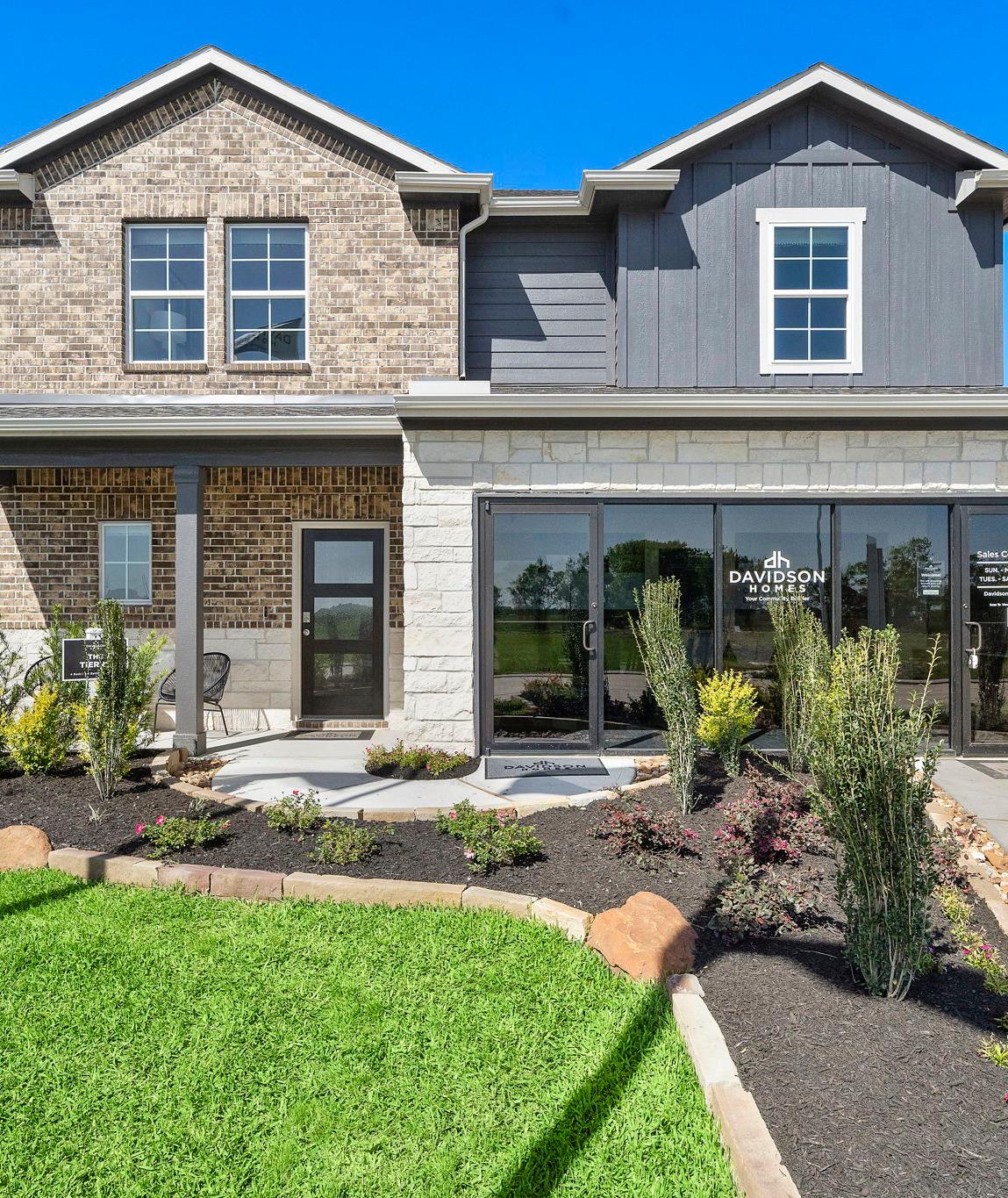 Open-concept kitchen and dining area in Emberly Beasley TX Davidson Homes with hardwood floors, large windows, and modern island