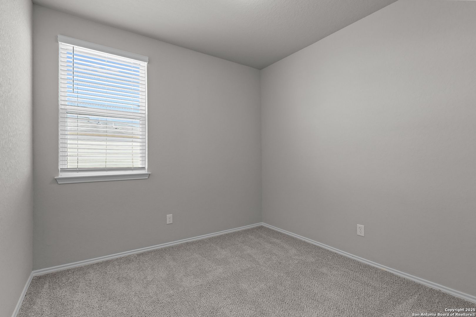 Bright secondary bedroom with gray walls, beige carpet, and window blinds in Davidson Homes The Colorado B, San Antonio